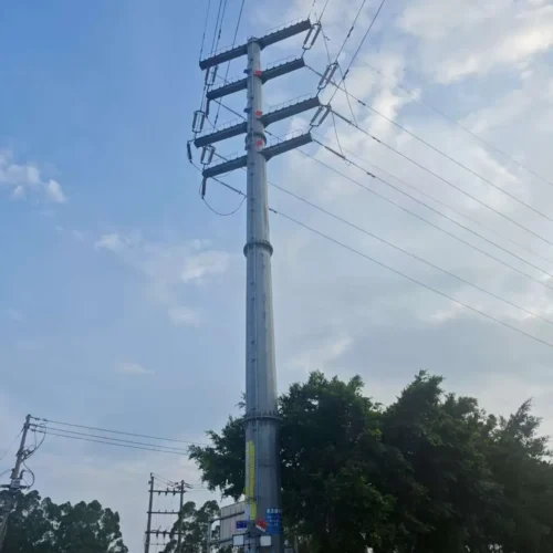 ​Steel power pole with cross-arms and lines against blue sky​