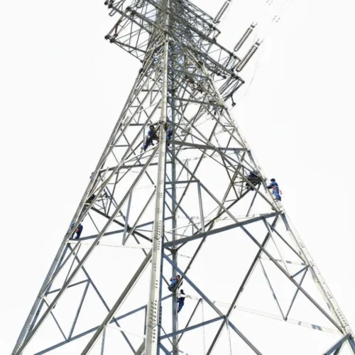 Workers maintaining tall transmission tower against