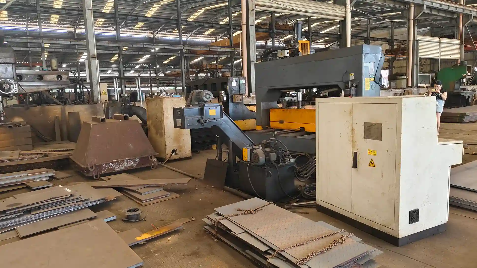 ​Industrial factory interior with metalworking machinery and sheet metal​