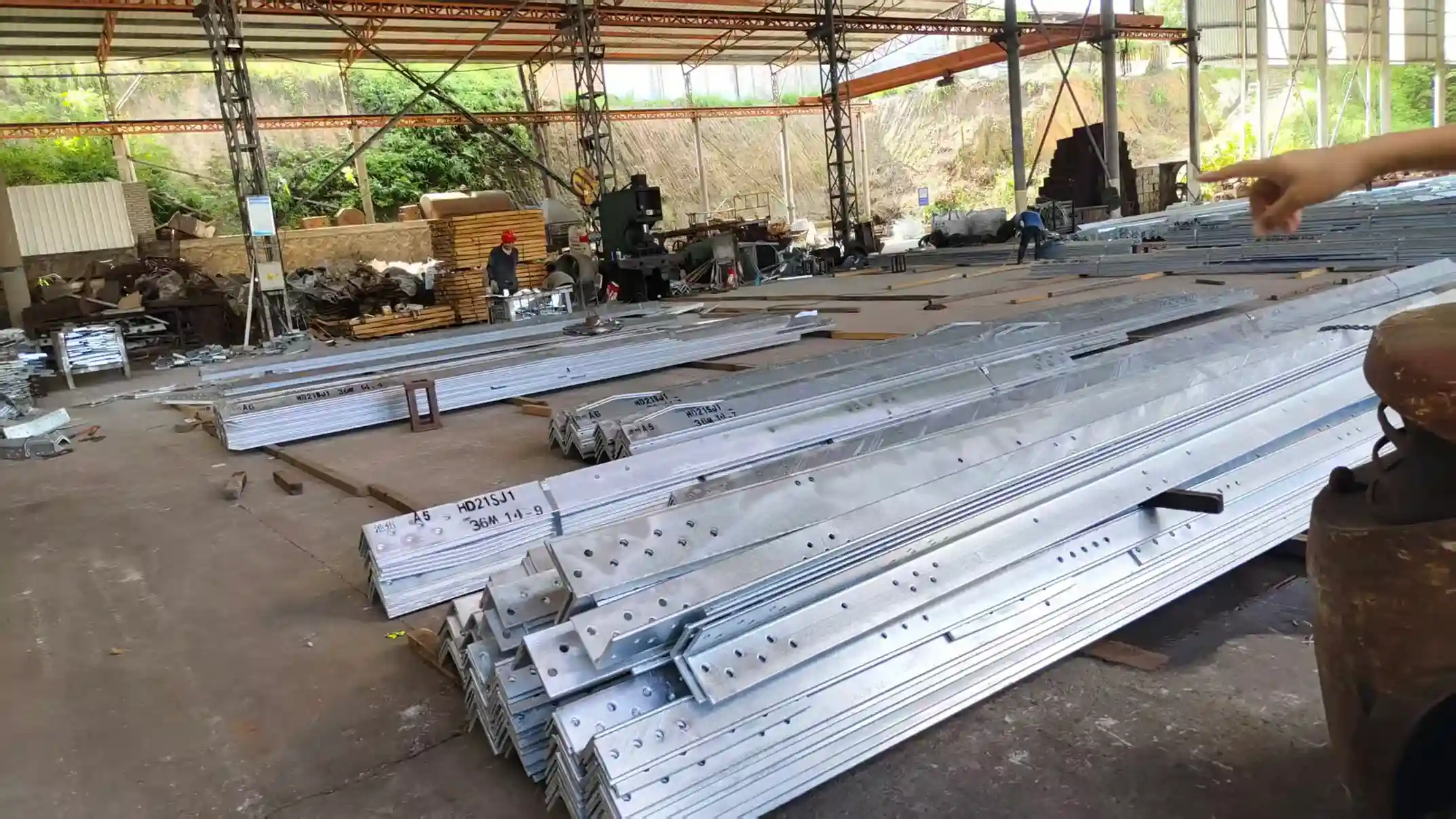 ​​Galvanized steel beams with HD21SJ1 codes in industrial workshop​