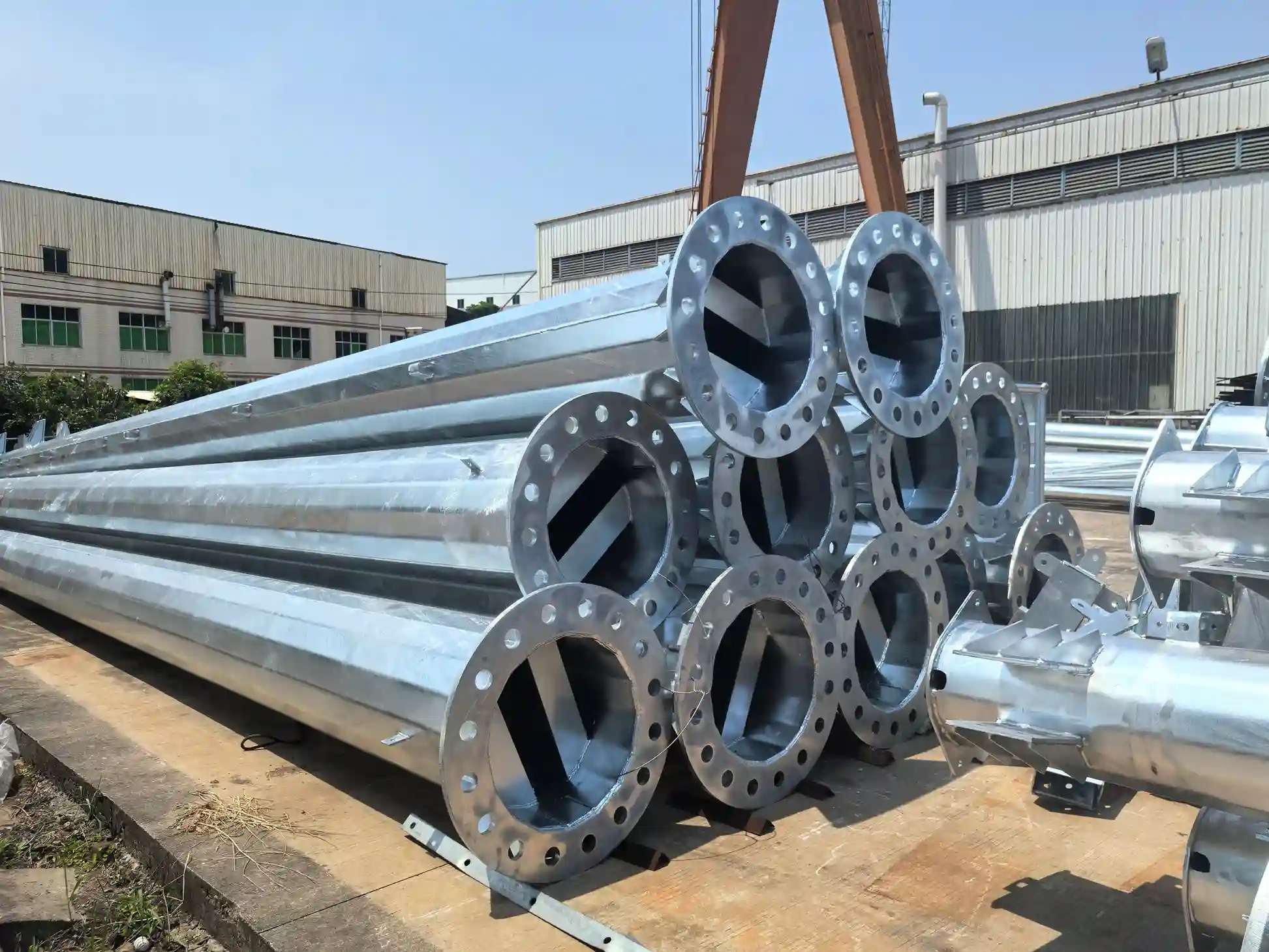 Galvanized steel pipes with flanges on wooden platform