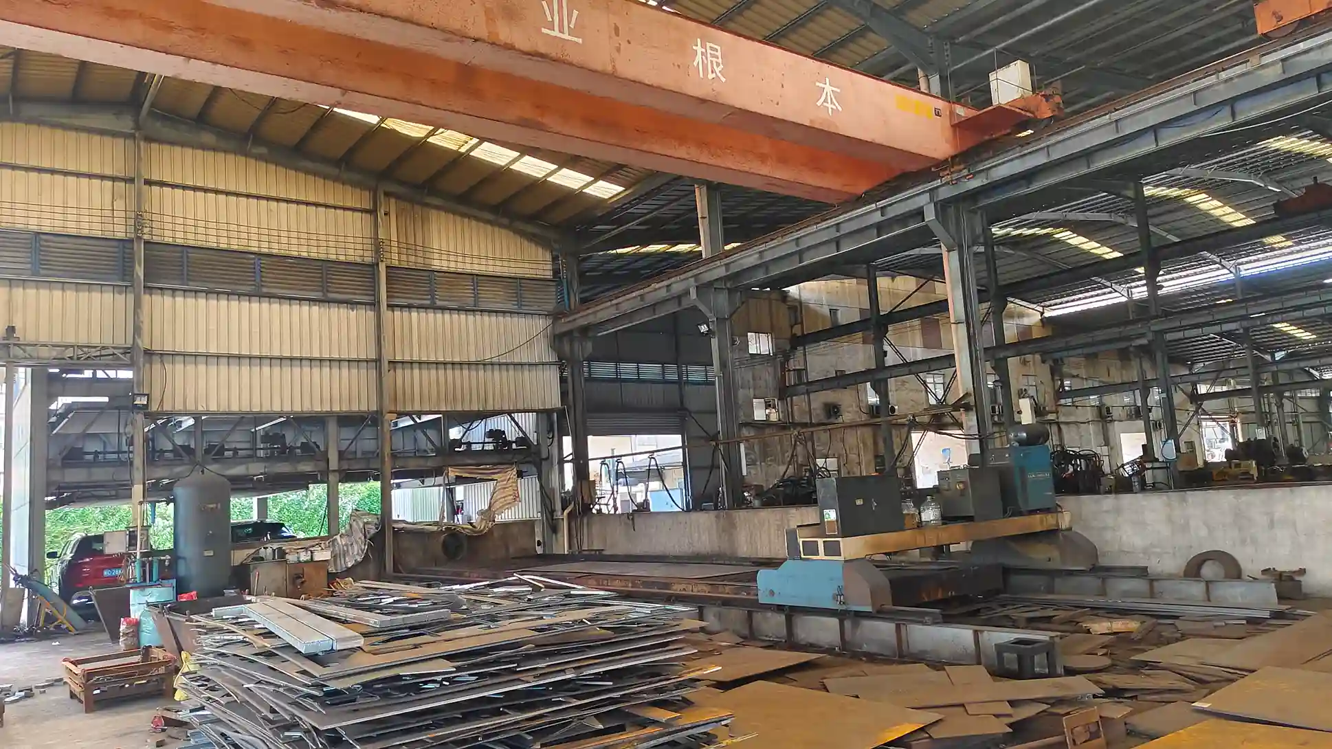 Minyi Steel Tower workshop with cranes and stacked steel plates